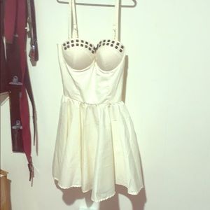 Off white dress with black studs around bust.